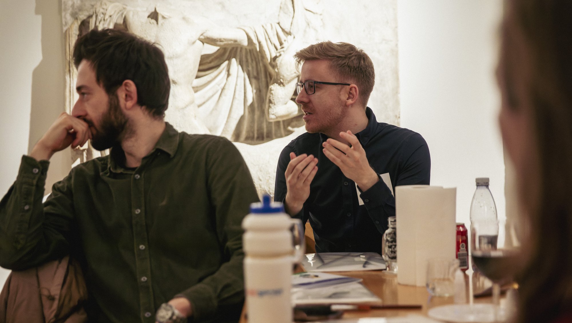 Shows a member of the audience posing a question.